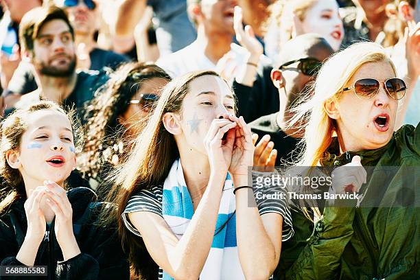 mother and daughters cheering during soccer match - crowd cheering stock pictures, royalty-free photos & images