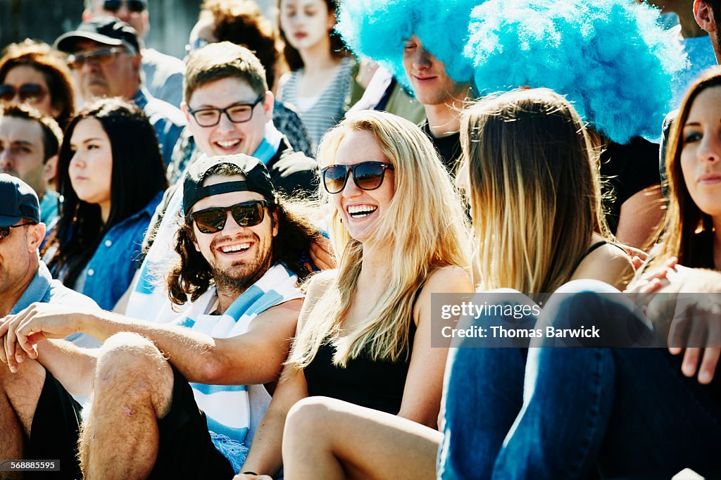 Laughing group of friends watching soccer match