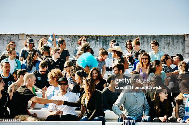 crowd of sports fans sitting in stadium - large group of people foto e immagini stock