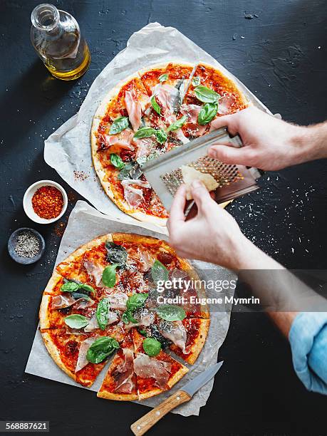 pizza with prosciutto, basil and parmesan cheese - grattugia foto e immagini stock