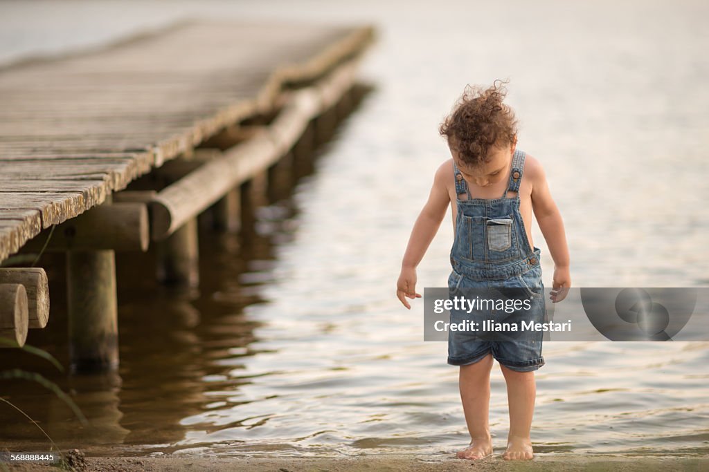 Boy on a lake's beach