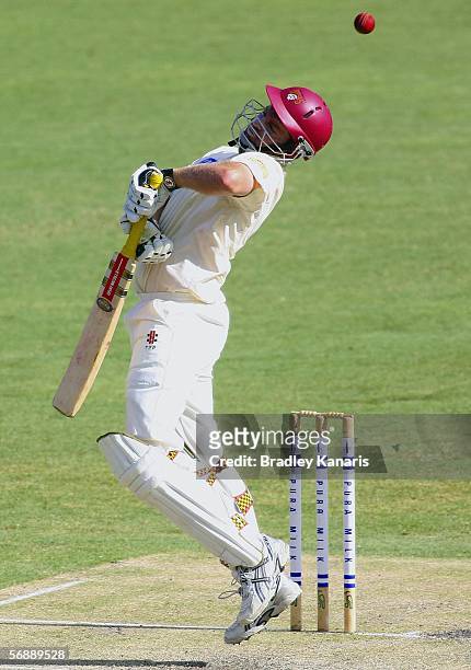 Clinton Perren of the Bulls avoids being hit by the ball during day two of the Pura Cup match between the Queensland Bulls and the South Australian...