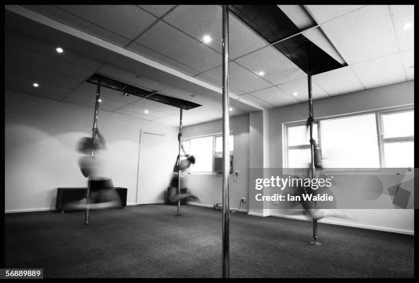 Poledancing students Danielle Grimmond and Charlotte Priestley practice a move from Polestars Australia instructor Stephanie Kite during a...