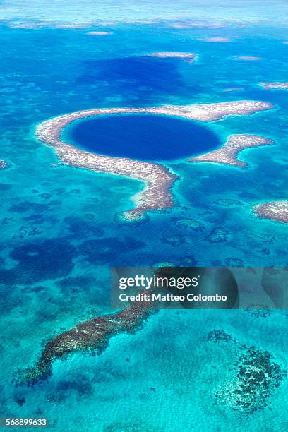 aerial of the blue hole, lighthouse reef, belize - natural landmark stock-fotos und bilder