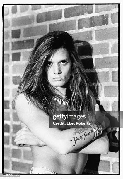 Portrait of singer Sebastian Bach, of the band 'Skid Row', standing in front of a brick wall in Orlando, Florida, 1989.