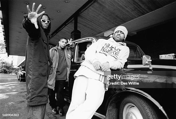 Portrait of the band 'Naughty by Nature' posing next to a taxi, circa 1992.