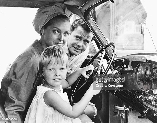 Actress Nadja Tiller at the wheel of a car with her daughter Natascha, as her husband Walter Giller looks on, during their vacation at the Lido in...