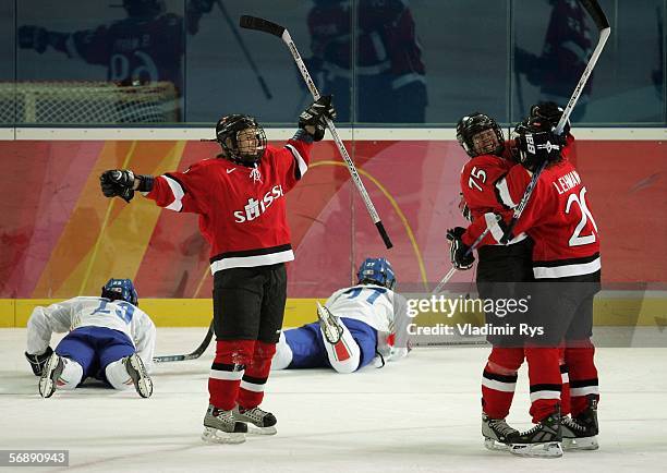 Kathrin Lehmann celebrates with Jeanette Marty of Switzerland after Lehmann scored the fourth goal in the first period during the women's ice hockey...