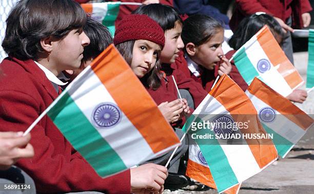 Indian Kashmiri school children hold Indian national flags near Kaman Bridge along the Line of Control between India and Pakistan, some 120 kms north...