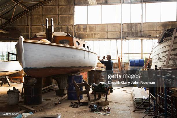 Boat builder working in his workshop.