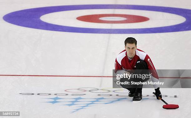 Brad Gushue of Canada watches the stone during the preliminary round of the men's curling between Canada v USA during Day 10 of the Turin 2006 Winter...