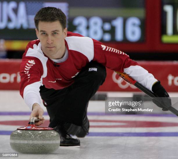 Brad Gushue of Canada eyes the stone during the preliminary round of the men's curling between Canada v USA during Day 10 of the Turin 2006 Winter...
