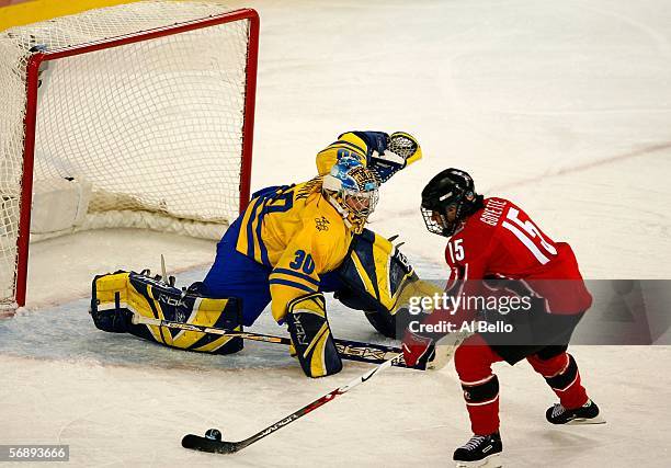 Danielle Goyette of Canada takes a shot on goal in front of goalie Kim Martin of Sweden during the final of the women's ice hockey during Day 10 of...