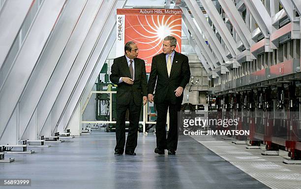 Auburn Hills, UNITED STATES: US President George W. Bush speaks with Subhendu Guha , president of United Solar Ovanics, while touring the United...