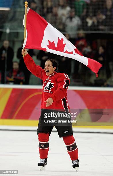Danielle Goyette of Canada waves a Canadian flag to celebrate their 4-1 victory over Sweden to win the gold medal in women's ice hockey during Day 10...
