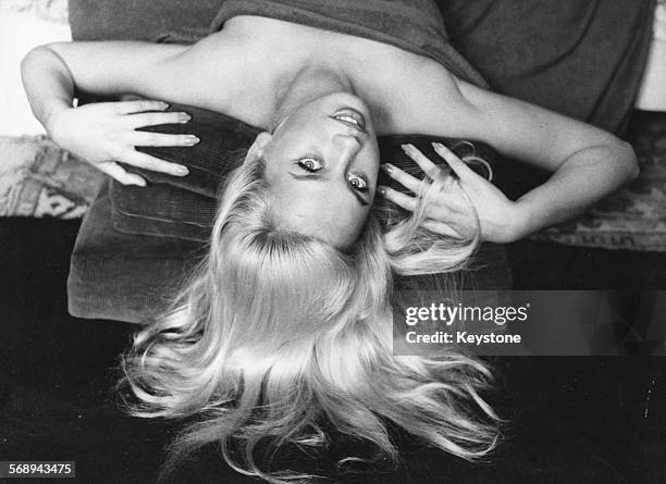 Portrait of actress Barbara Valentin reclining back with her hair fanned out, Munich, September 23rd 1959.