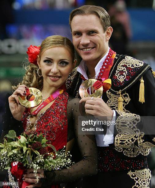 Tatiana Navka and Roman Kostomarov of Russia receive their gold medal after the Free Dance program of the figure skating during Day 10 of the Turin...