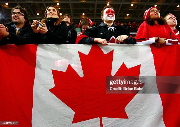 Fans watch as Team Canada receives the gold medal following their 4-1 victory over Sweden during the final of the women's ice hockey on Day 10 of the...