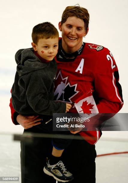 Hayley Wickenheiser of Canada celebrates with her son Noah after their 4-1 victory over Sweden to win the gold medal in women's ice hockey during Day...
