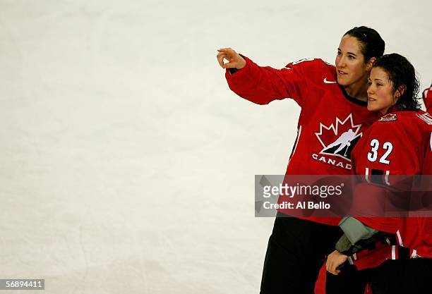 Caroline Ouellette and Charline Labonte of Canada point to the crowd after their 4-1 victory over Sweden during the final of the women's ice hockey...