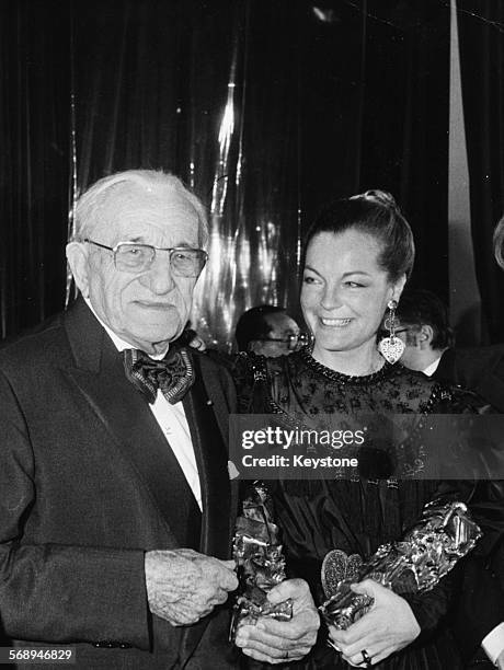 Actors Charles Vanel and Romy Schneider holding their statuettes at the Cesar Awards, where they received the Honorary Cesar and Best Actress awards...