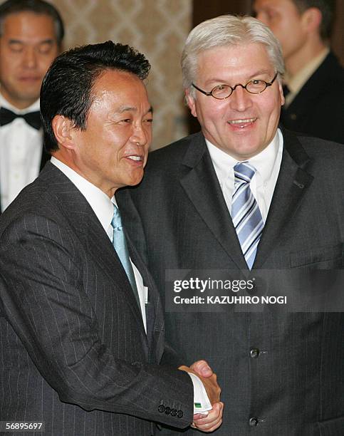 Visiting German Foreign Minister Frank-Walter Steinmeier shakes hands with his Japanese counterpart Taro Aso prior to their talks at the Foreign...