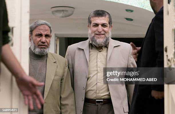 Senior member of the Radical Islamic Jihad movement Nafez Azam walks out with Hamas leader and MP Mahmud al-Zahar following their meeting in Gaza...