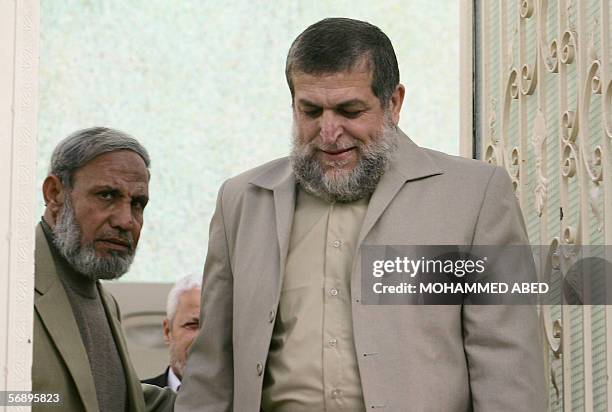 Senior member of the Radical Islamic Jihad movement Nafez Azam walks out with Hamas leader and MP Mahmud al-Zahar following their meeting in Gaza...