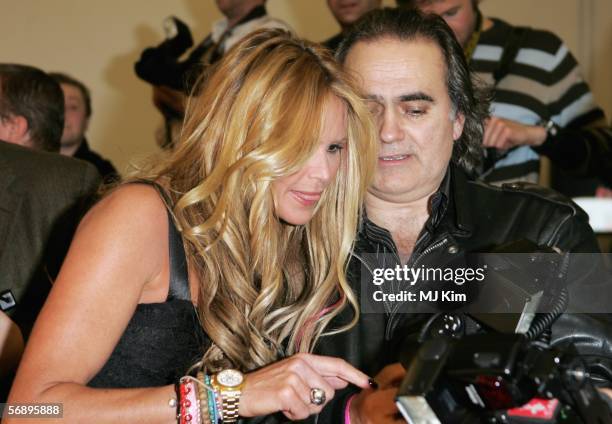 Model Elle Macpherson looks at images with photographer Dave M. Benett in the Awards Room at the ELLE Style Awards 2006, the fashion magazine's...