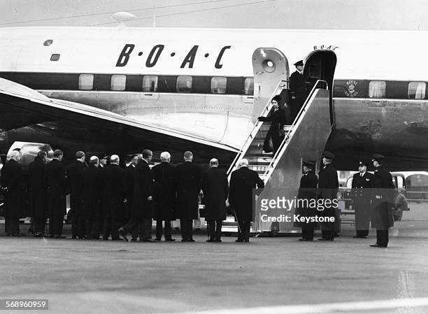 Queen Elizabeth II and Prince Philip, the Duke of Edinburgh, leaving their BOAC airliner as they return from Kenya following the death of King George...