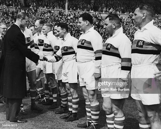 Prince Philip, the Duke of Edinburgh, shaking hands with rugby player D Ward as he meets the Bradford Northern Rugby League Team at the Cup Final,...