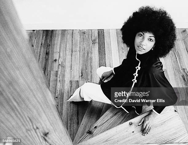 Portrait of singer Linda Lewis sitting on a staircase, July 1975.