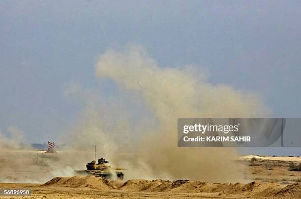 Soviet model T-72 Iraqi tank from Iraq's 9th Army Mechanized Division roars as it takes position during a training session at the Besmaya range near...