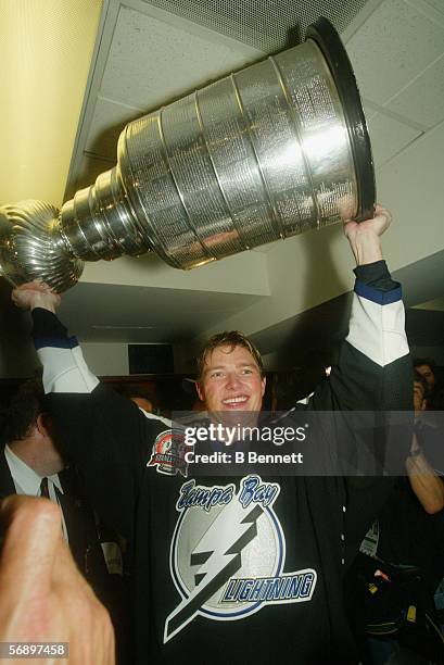 Ukrainian professional hockey player Ruslan Fedotenko hoists the Stanley Cup trophy over his head after the Lightning defeated the Calgary Flames in...