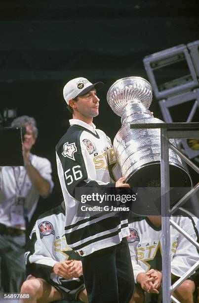 Russian professional hockey player Sergei Zubov of the Dallas Stars holds the Stanley Cup as he celebrates their championship victory over the...