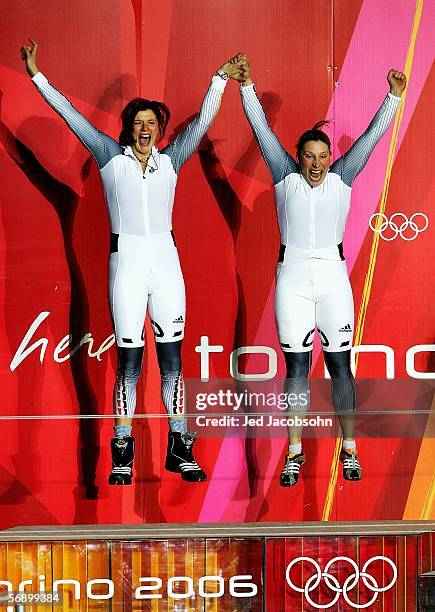 Gold Medal winners Sandra Kiriasis and Anja Schneiderheinze of Germany 1 jump up in celebration on the podium after the Two Woman Bobsleigh Final on...