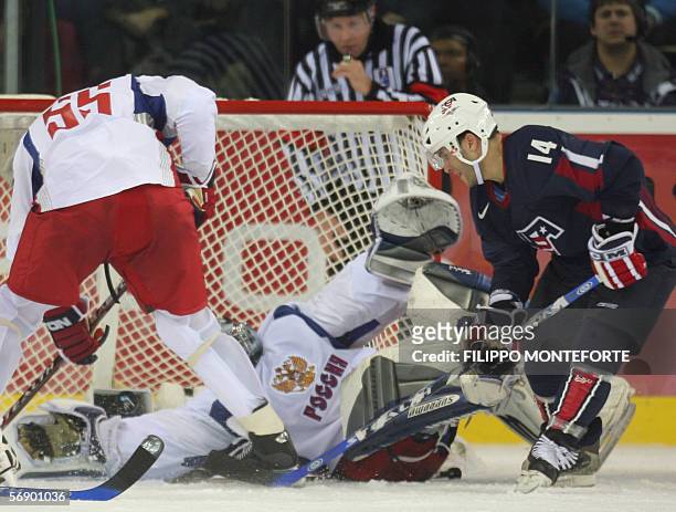 Brian Gionta scores against Russian goalie Maxim Sokolov and Russian Sergei Gonchar during the ice hockey men's preliminary game USA vs Russia at the...