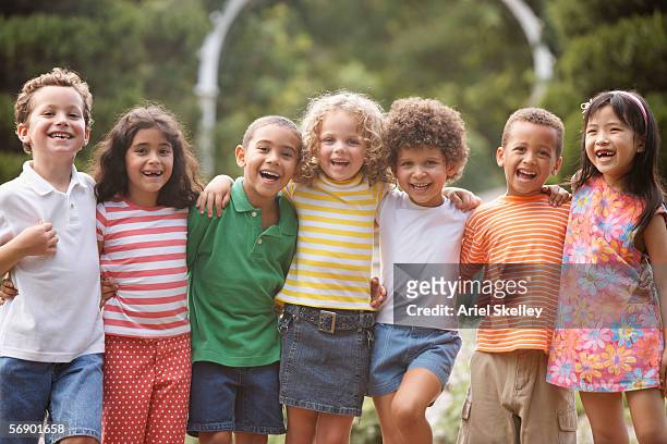 portrait of children arm in arm - group of kids stock pictures, royalty-free photos & images