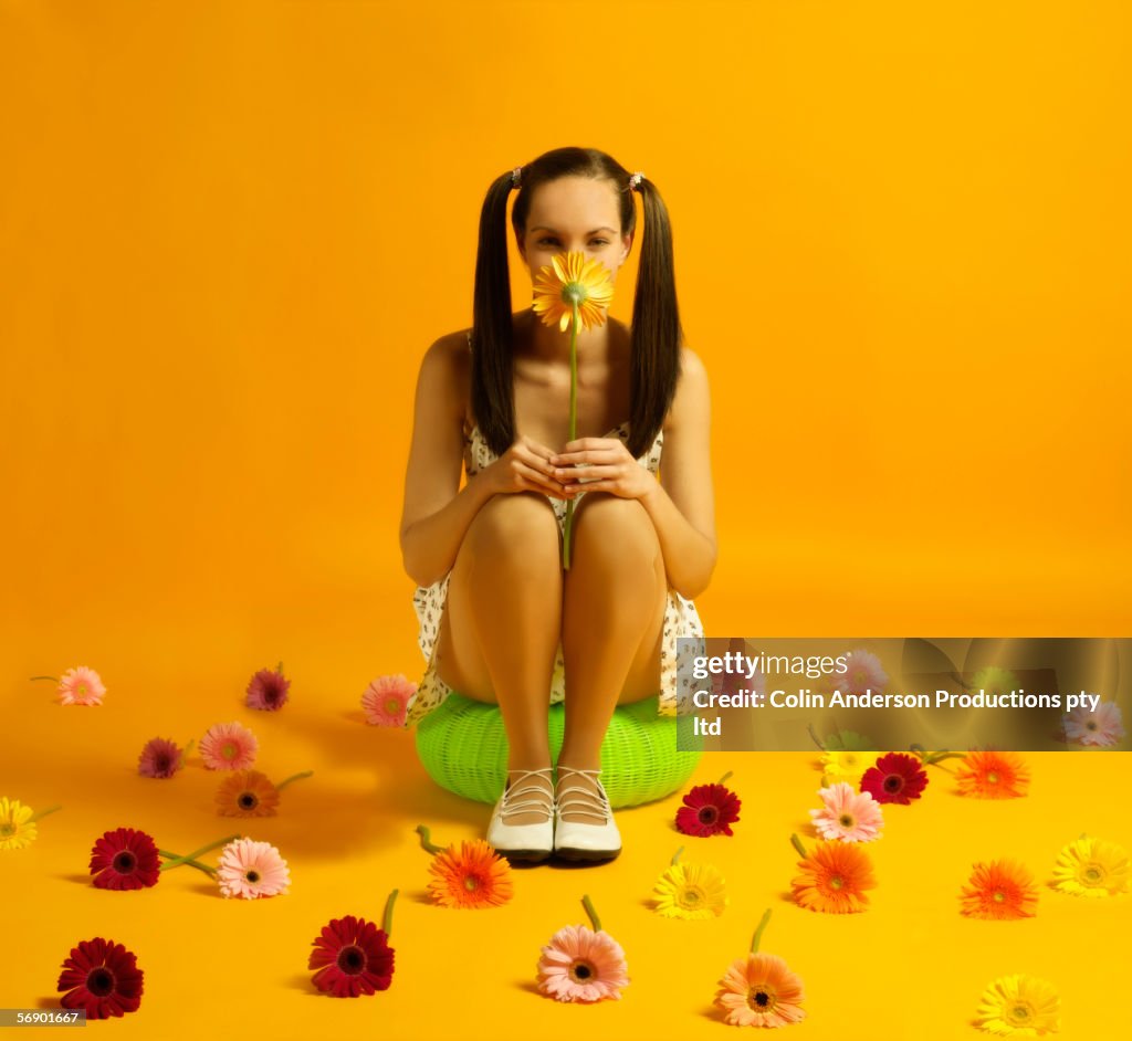 Seated woman holding flower