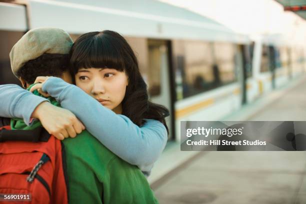 couple hugging at train station - girlfriend leaving stock pictures, royalty-free photos & images
