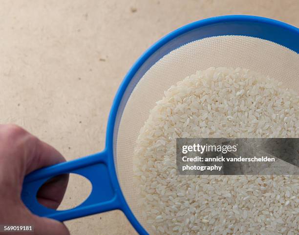 Using A Sieve For Rice Sieving Rice Photos and Premium High Res Pictures - Getty Images