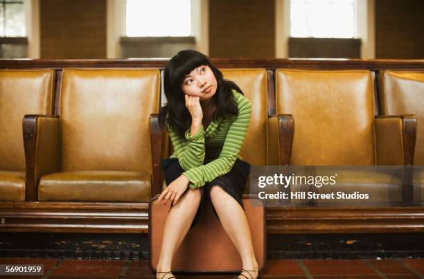 woman sitting with suitcase - boredom concept stock pictures, royalty-free photos & images