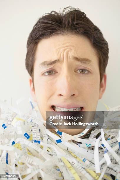 close-up of a frustrated young man - buried paperwork stock pictures, royalty-free photos & images