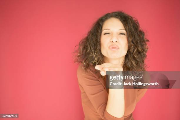 young woman blowing a kiss - blowing a kiss stockfoto's en -beelden