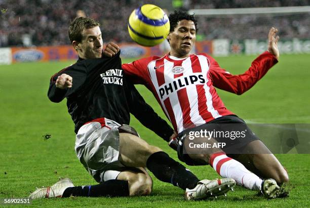 Eindhoven, NETHERLANDS: PSV Eindhoven's Michael Lamey vies with Olympique Lyonnais Francois Clerc during their Champions league football match, 21...