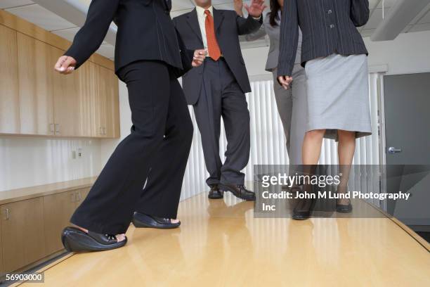 business professionals dancing on a table - political party stock-fotos und bilder