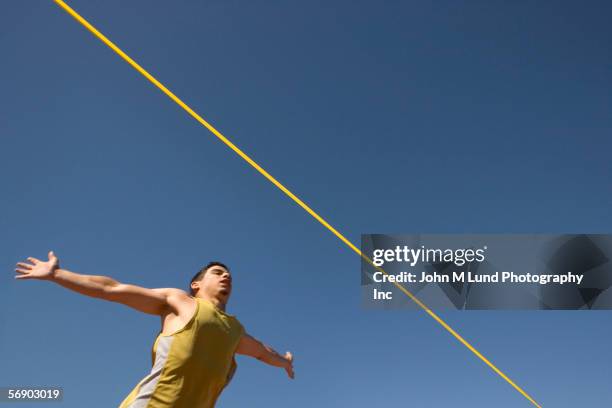 runner preparing to cross the finish line - close to finish line stock pictures, royalty-free photos & images