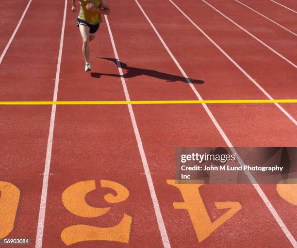 male runner approaching finish line - close to finish line stock pictures, royalty-free photos & images