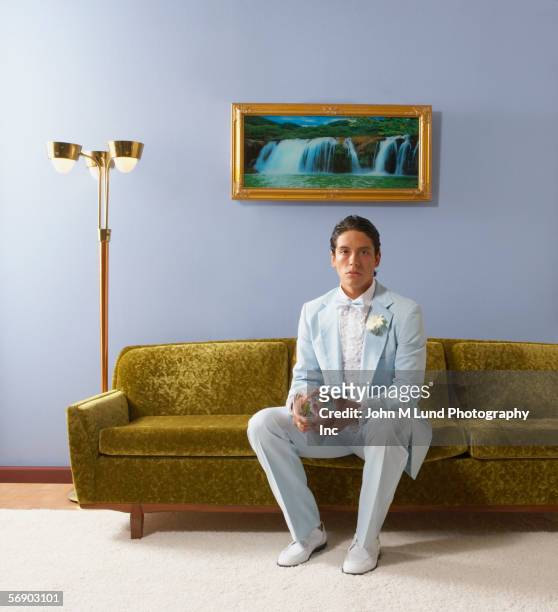 young man in tuxedo holding corsage - dinner jacket stock pictures, royalty-free photos & images