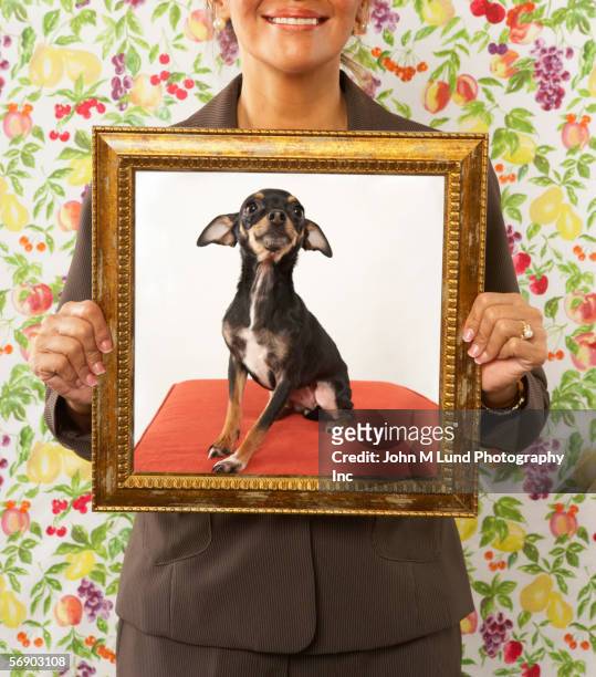 proud woman holding framed picture of dog - ugly people stock pictures, royalty-free photos & images